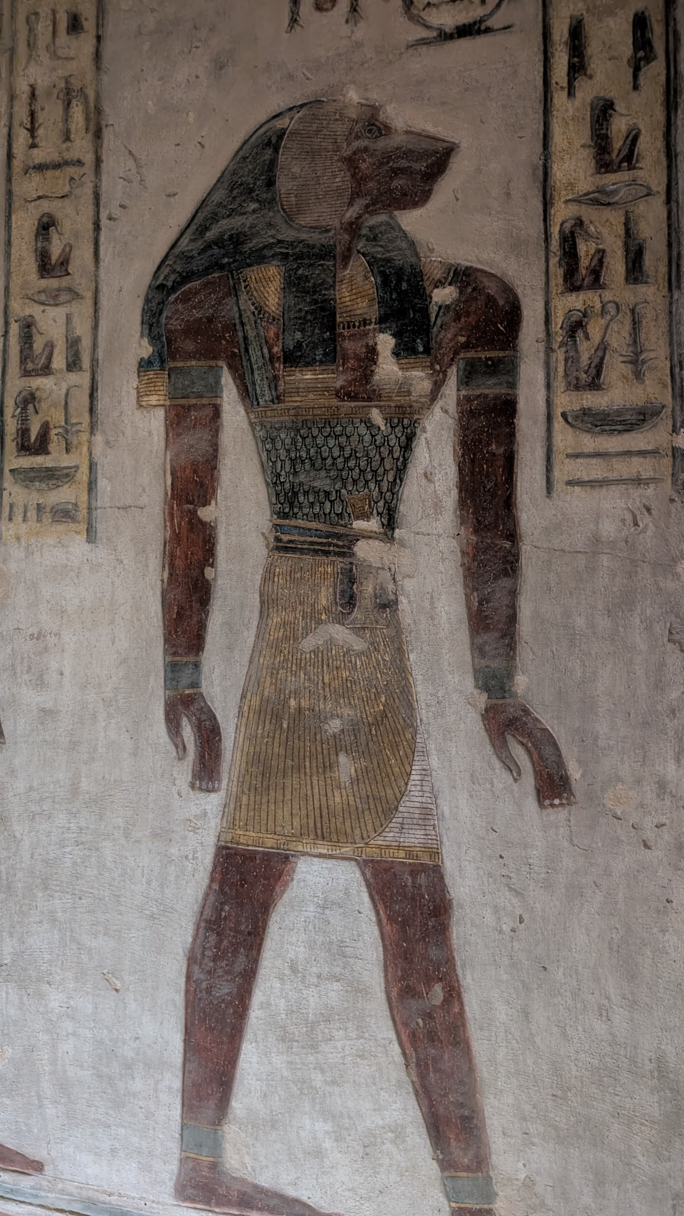 Anubis tomb painting in the Valley of the Kings, vivid colours on ancient stone