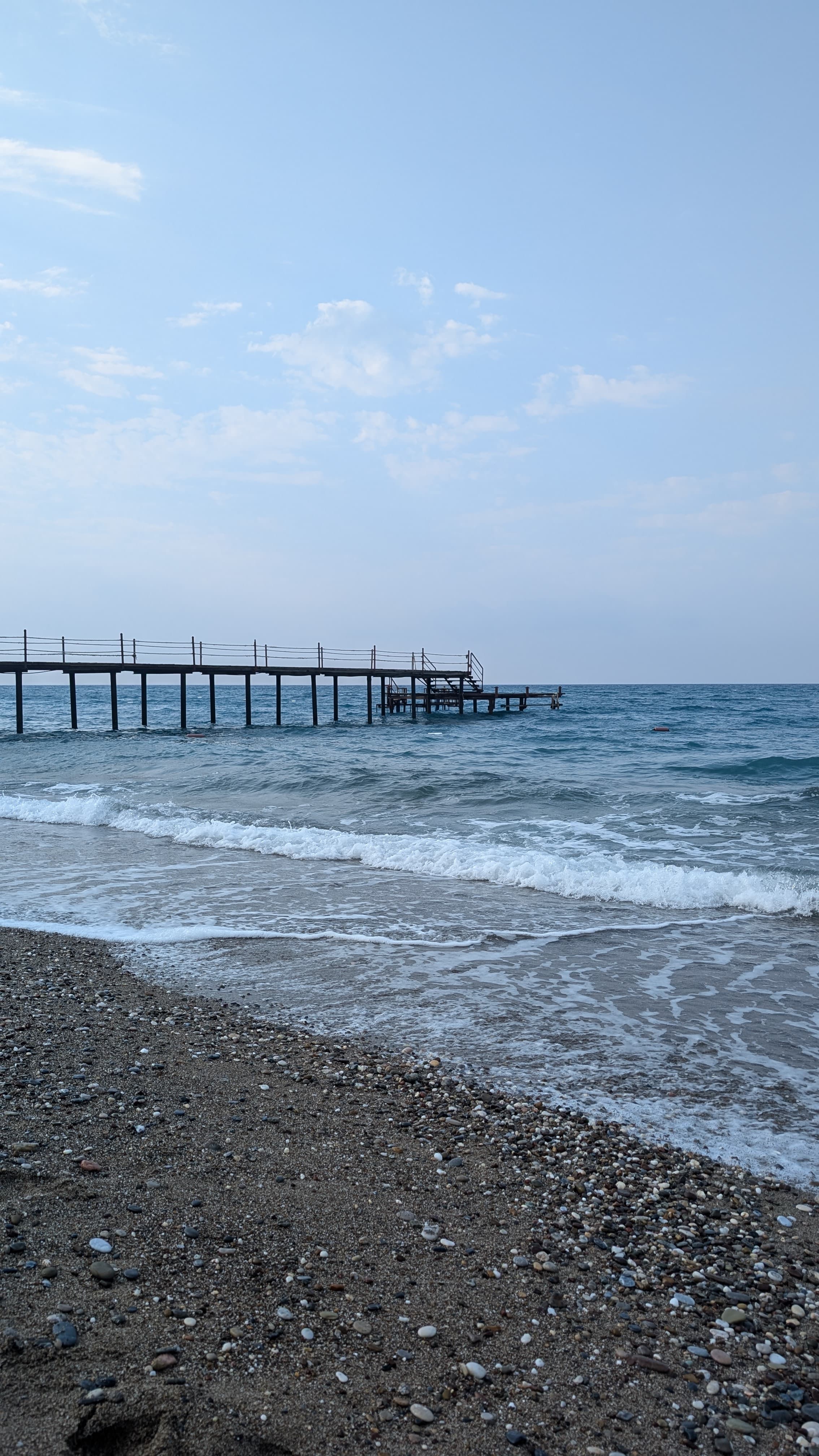 Yivli Minaret at dusk. Thirteenth-century Seljuk, fluted brick, the visual anchor of the whole old town.