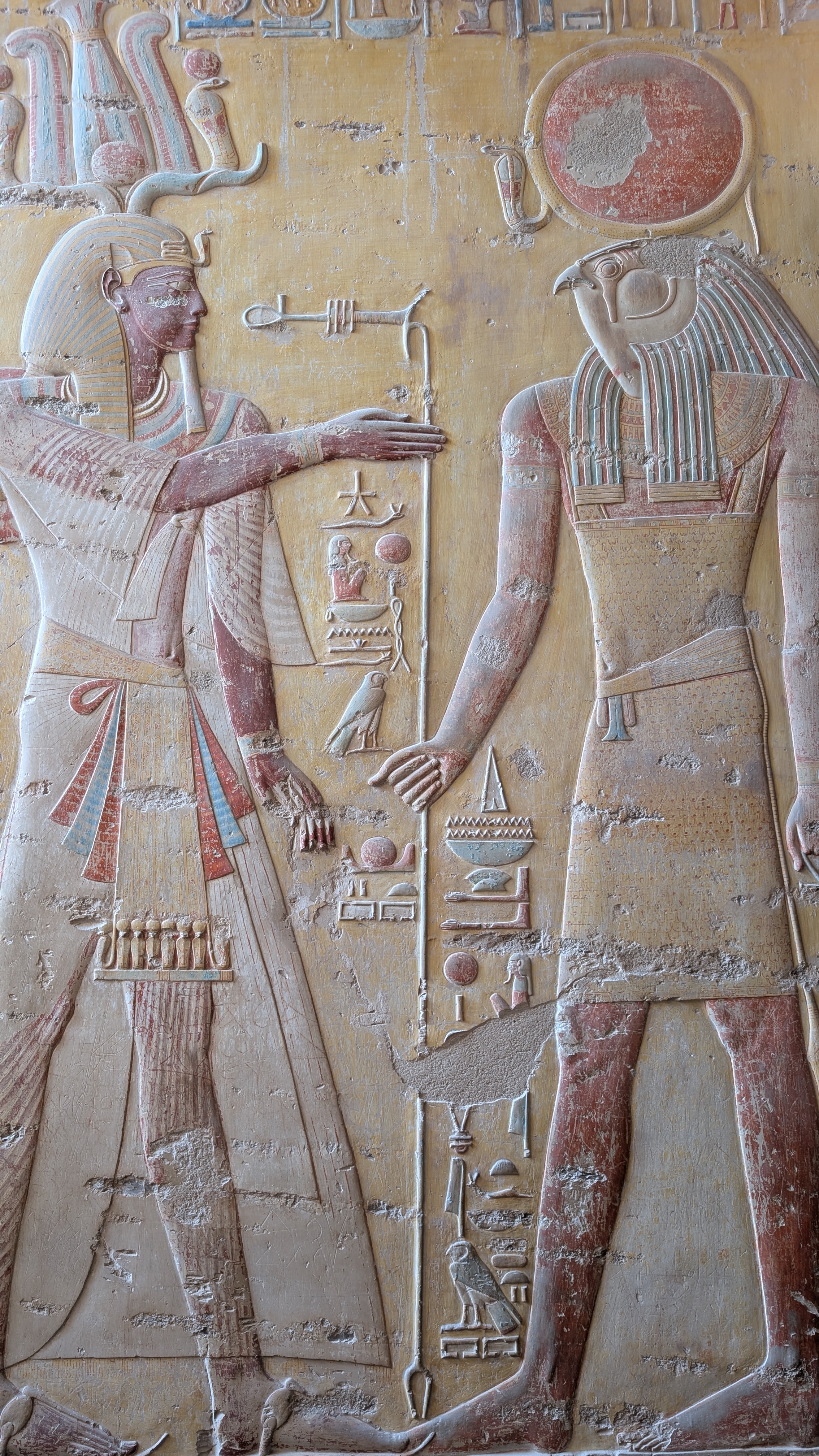 Stone relief carving of pharaoh and Horus with colour traces, Luxor Temple