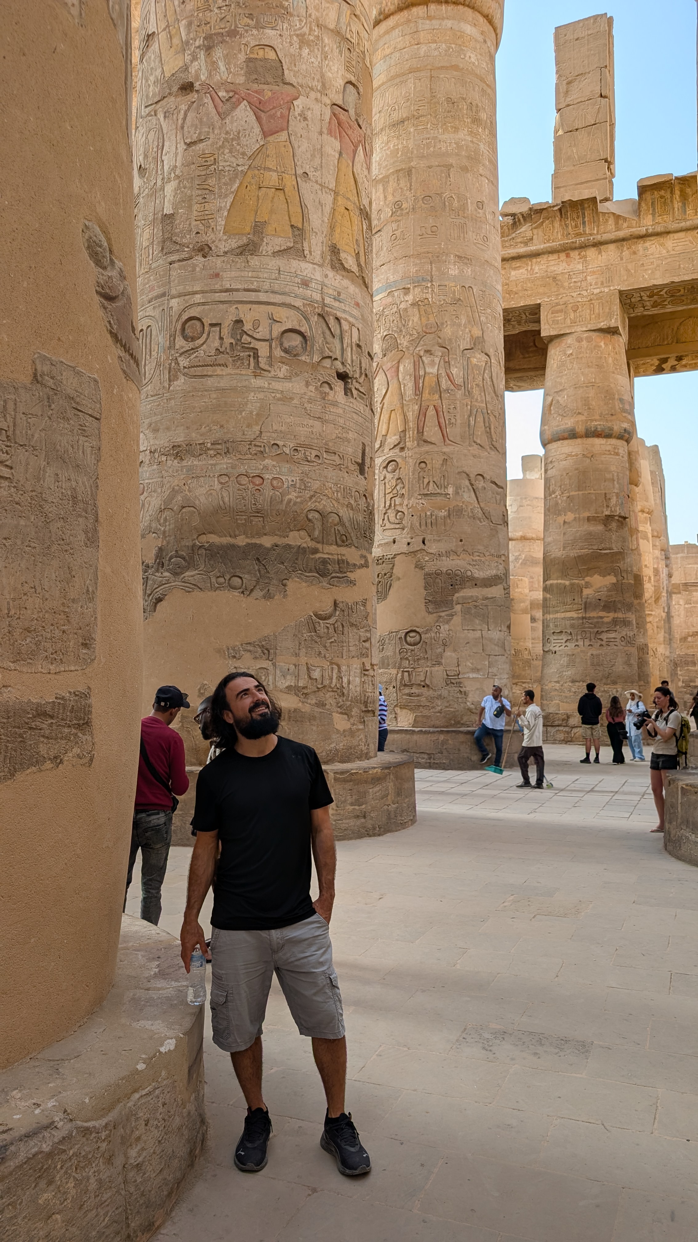Standing among the giant Karnak columns covered in hieroglyphs, looking up