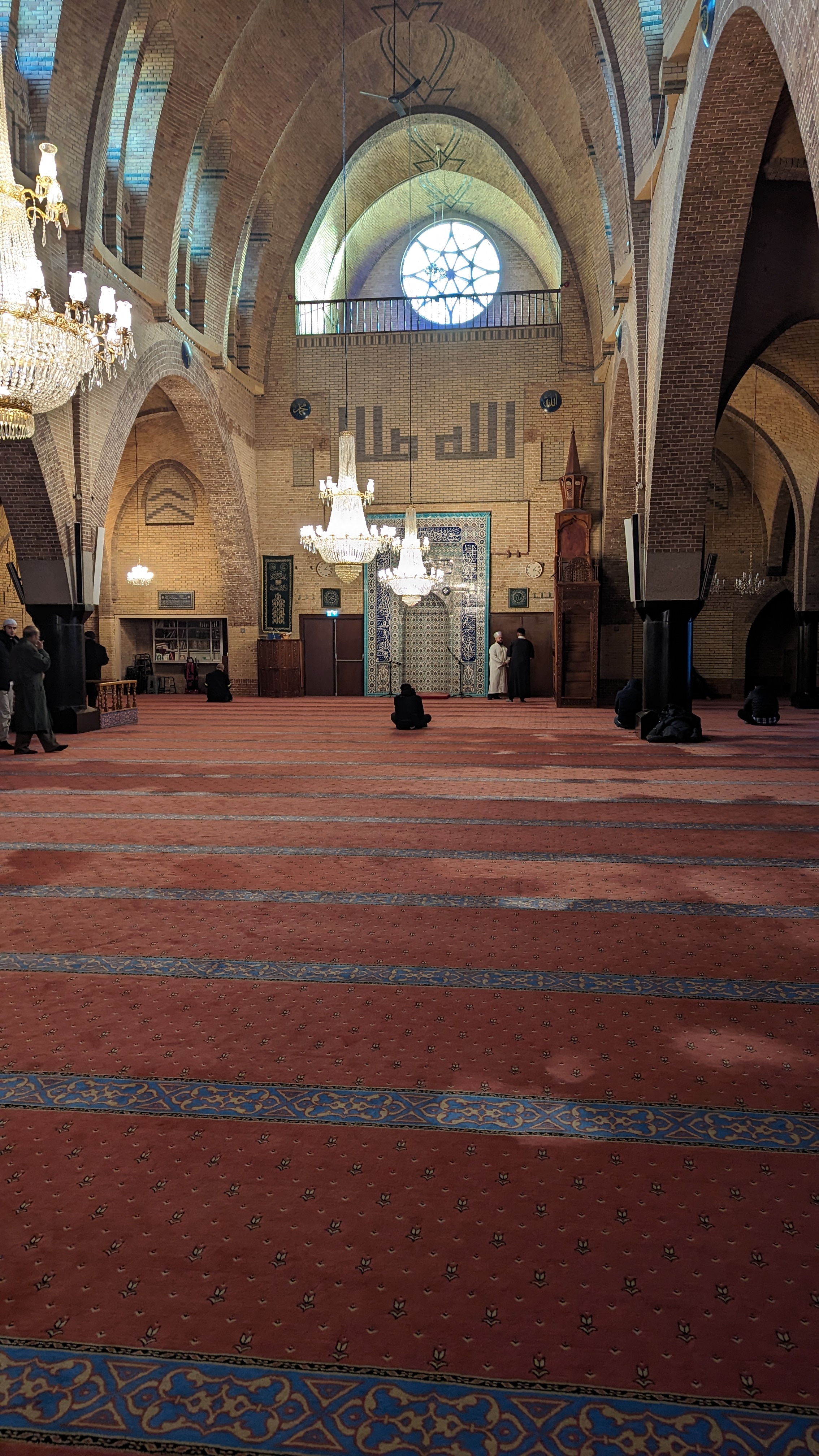 Amsterdam canal reflected in still water with tall narrow canal houses lining the bank