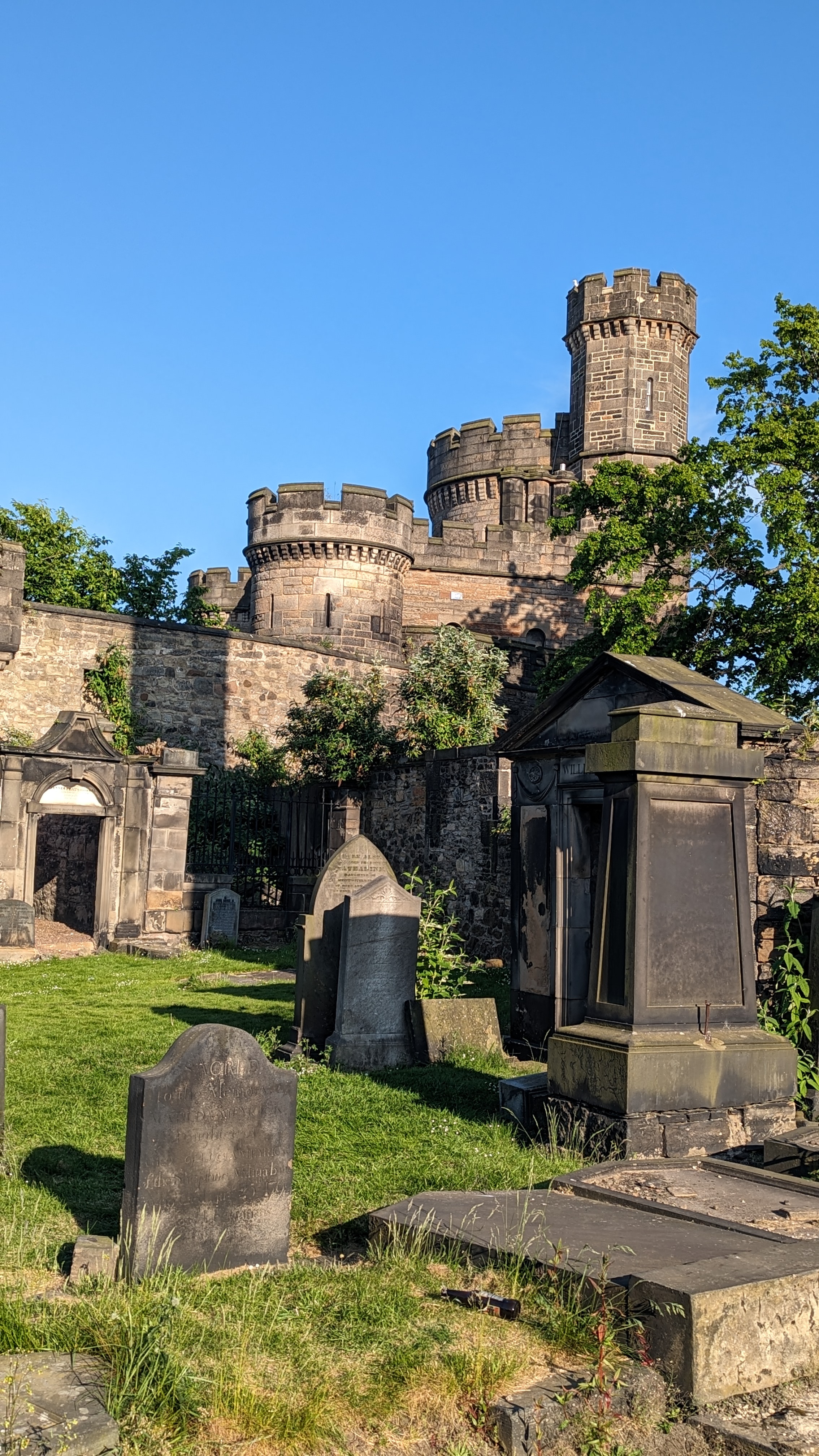 Old Calton Burial Ground with Edinburgh Castle towers visible above the gravestones