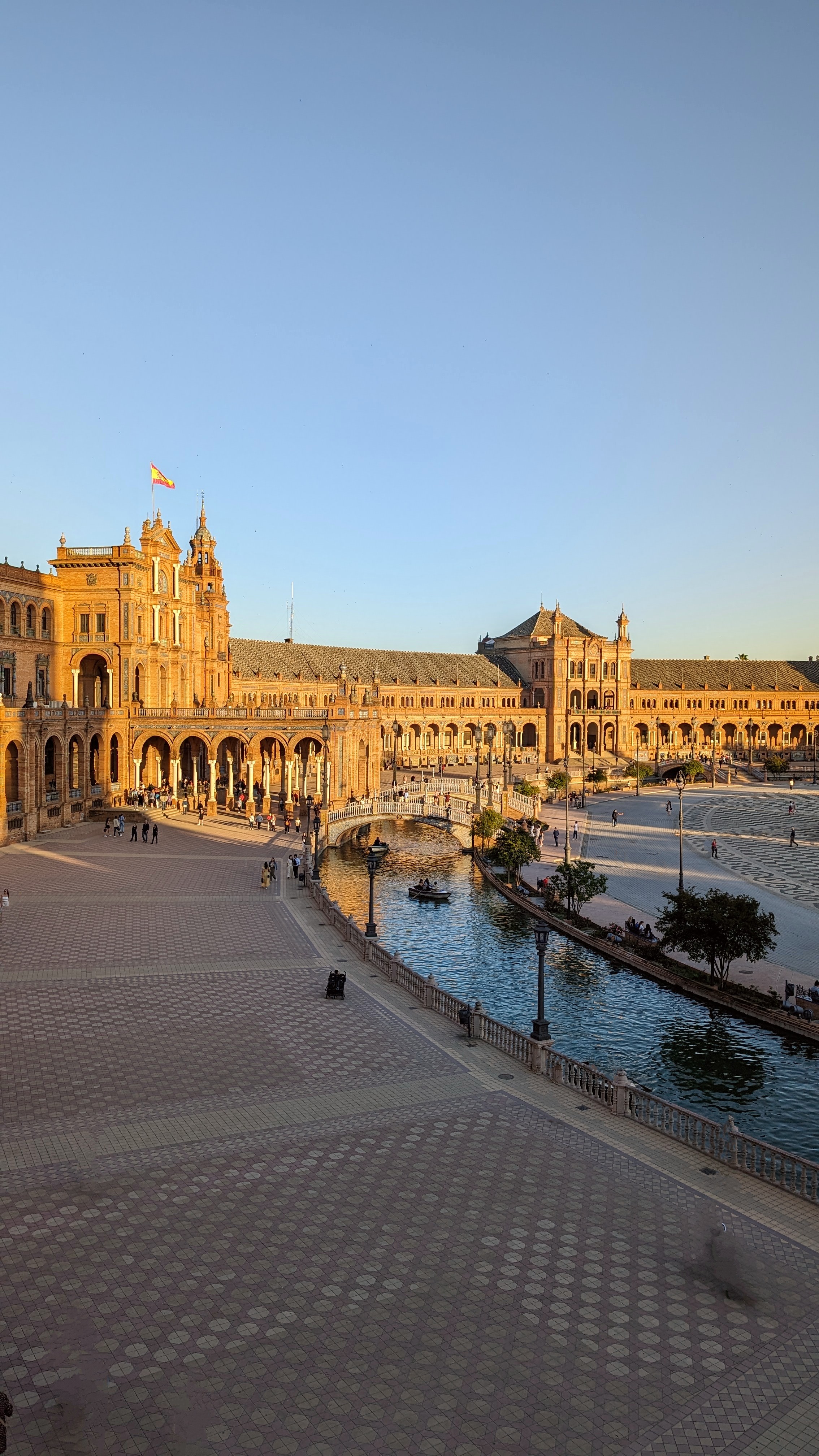 Plaza de España in Seville with its tiled alcoves and the canal in the foreground