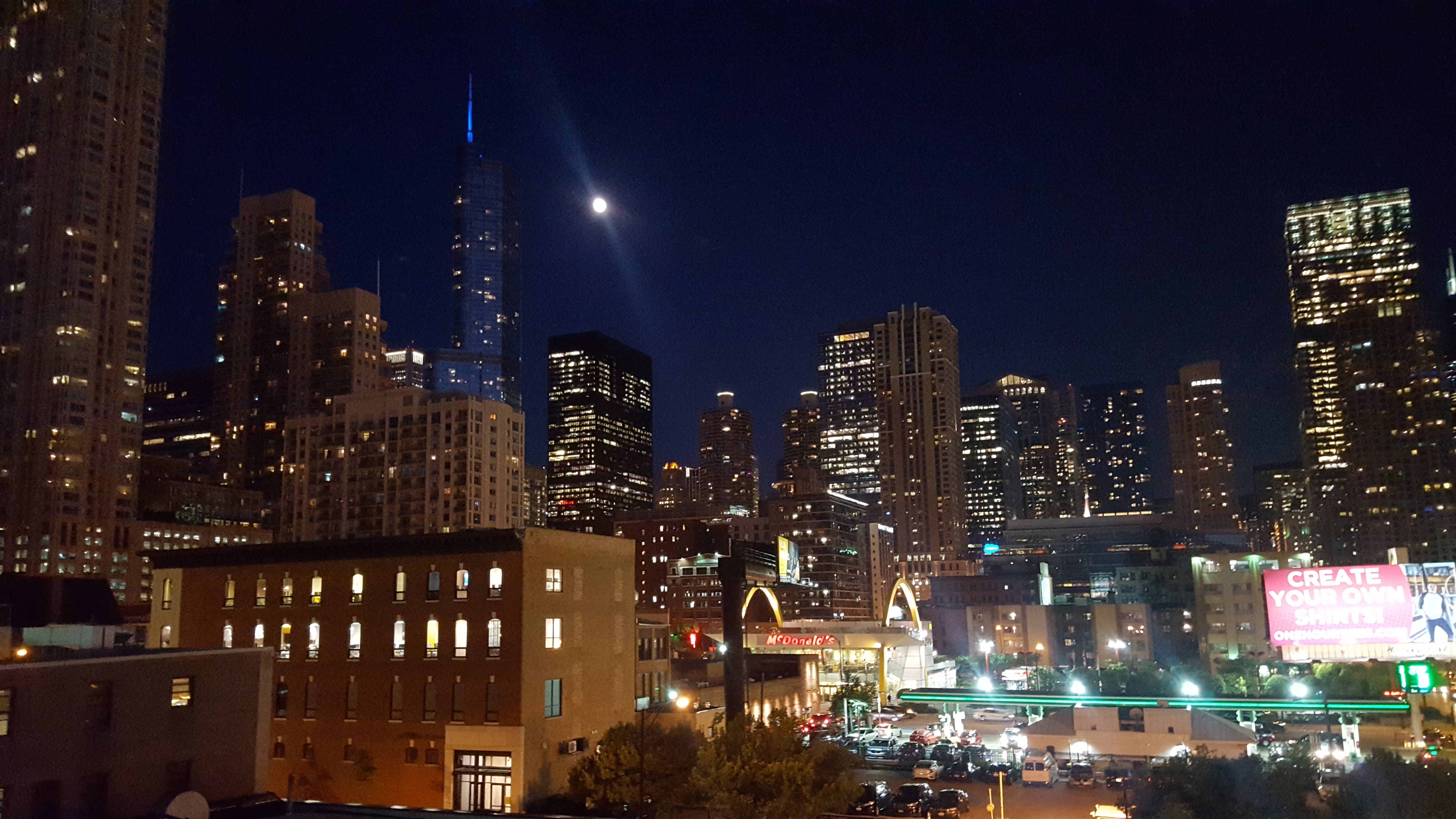 Chicago Navy Pier at dusk with the Ferris wheel lit and reflections in Lake Michigan