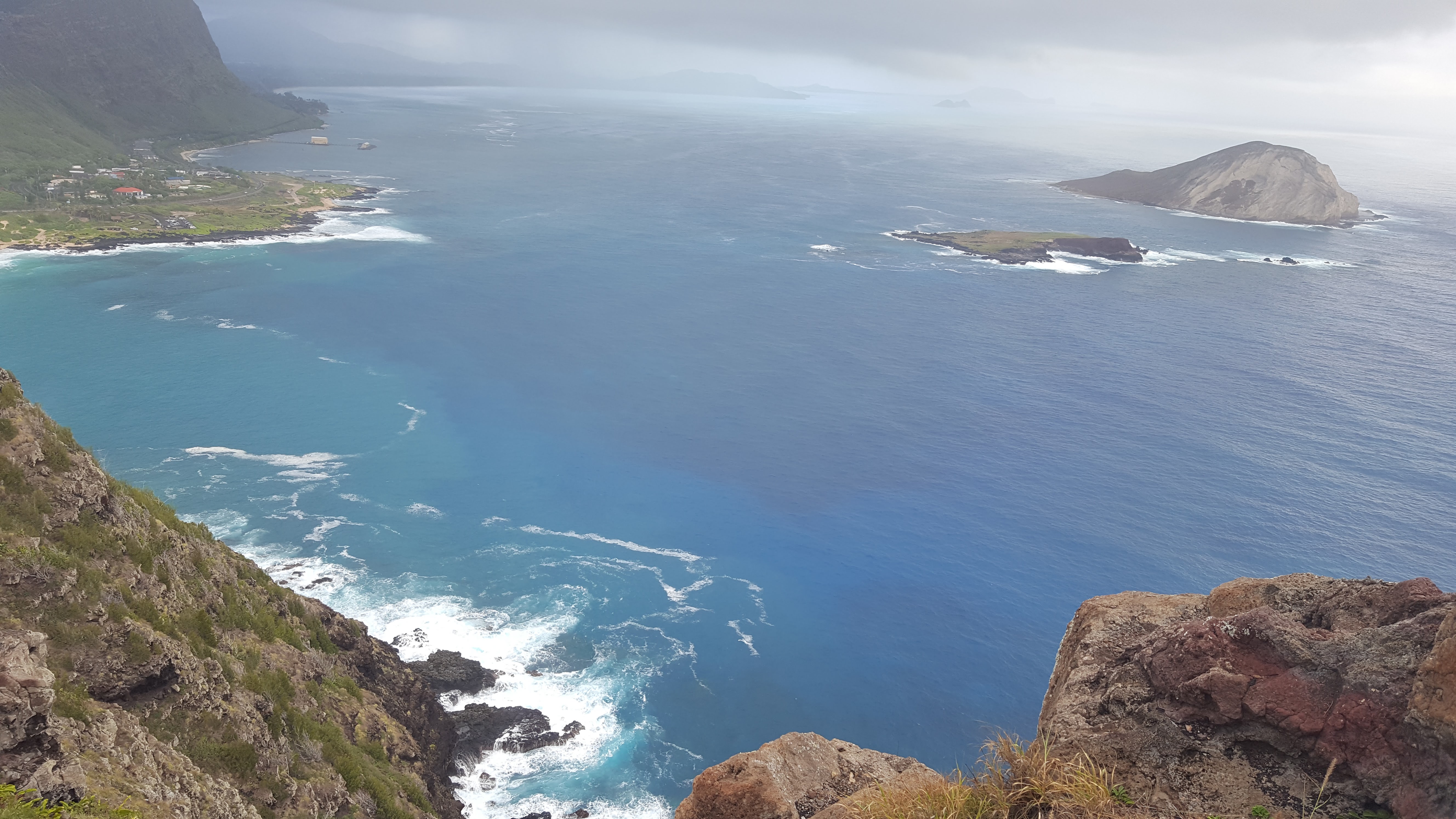 O'ahu north shore coastline with volcanic mountains and Pacific Ocean swells